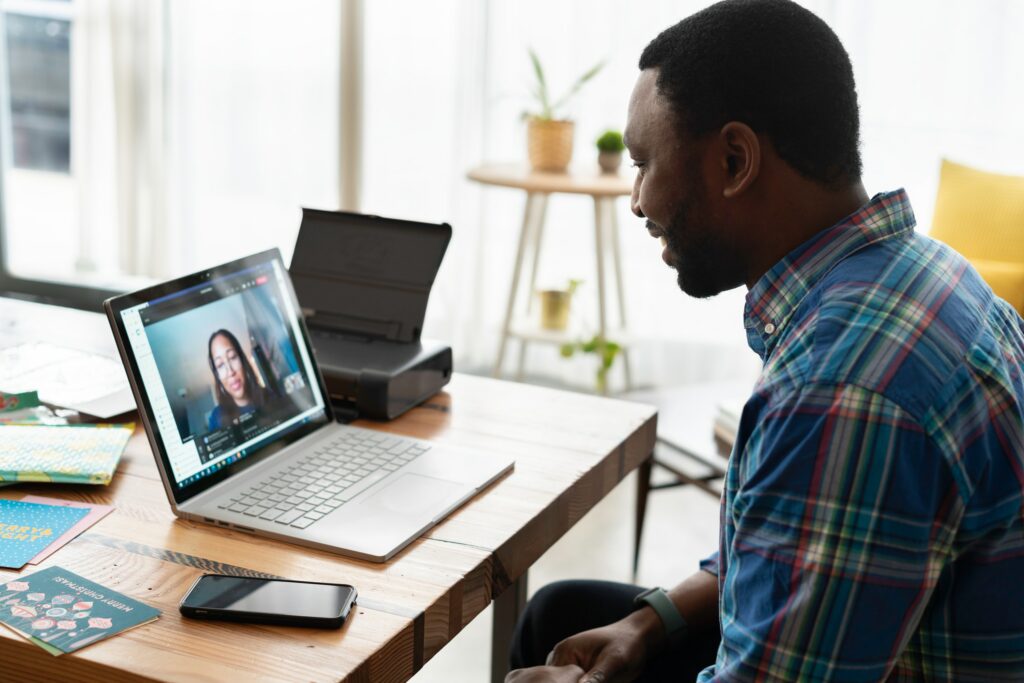 Man on video conference with woman